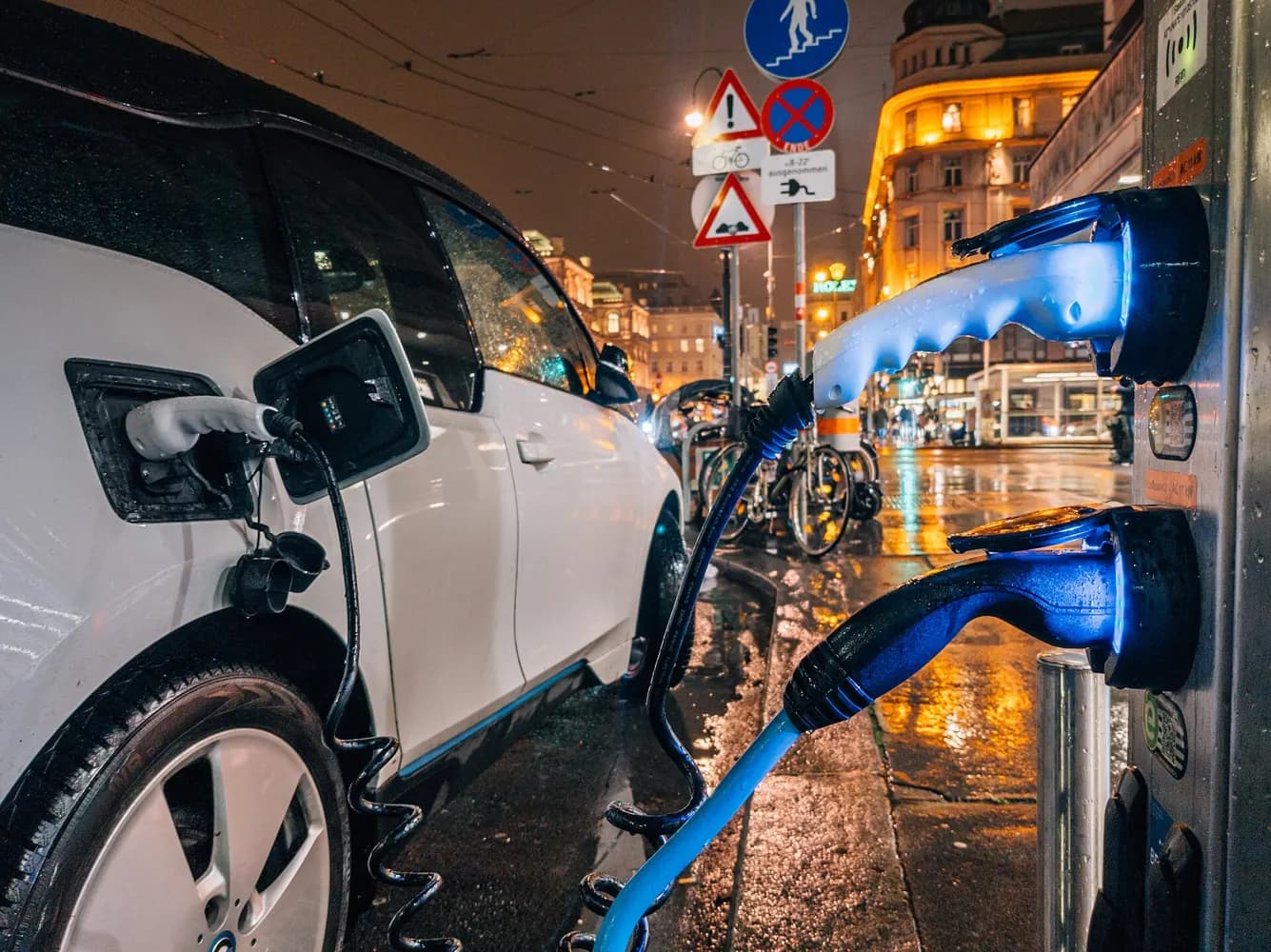 An electric car charging at night; illustrative image